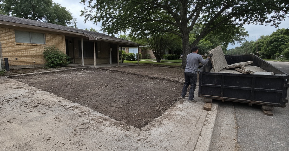 Concrete being pulled into the right of way portion of a driveway in Lakeway, the reinforcing bar showing ahead of the placement.